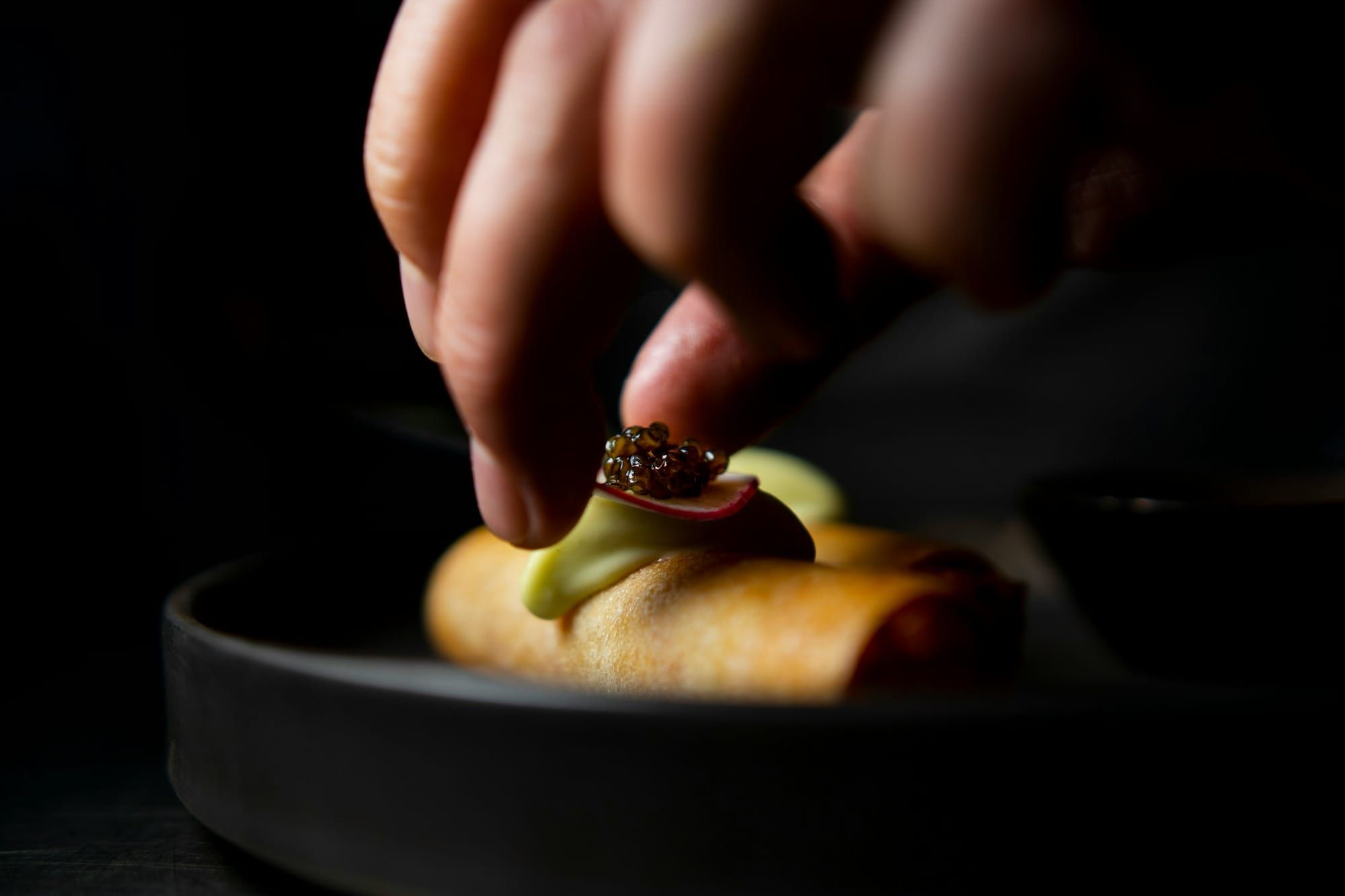 A caviar canapé finished by hand